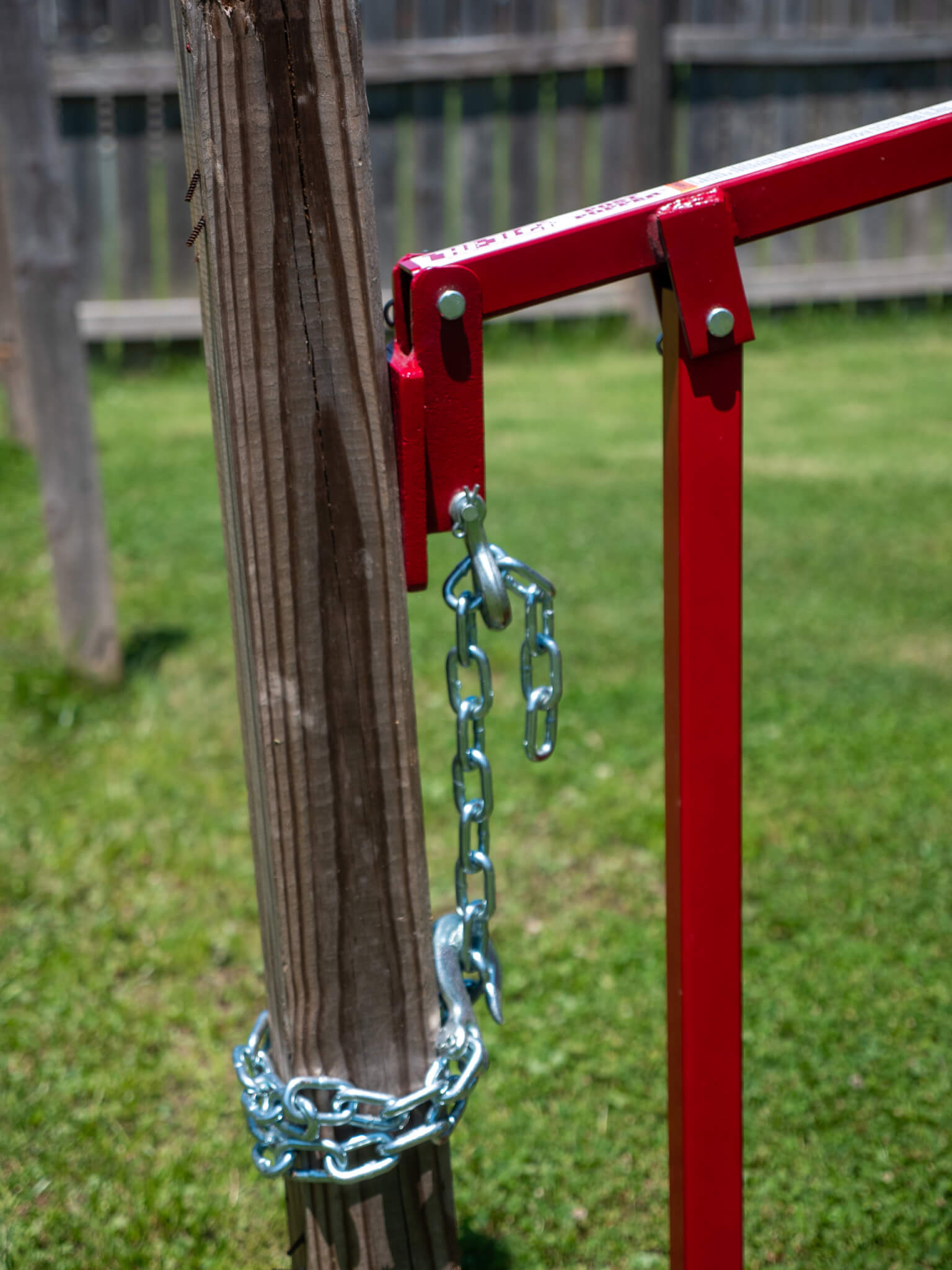 Post popper being used to remove a wood post